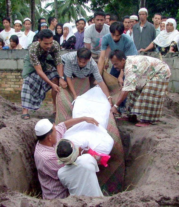 Relatives bury a Muslim demonstrator at a cemetery in Narathiwat province