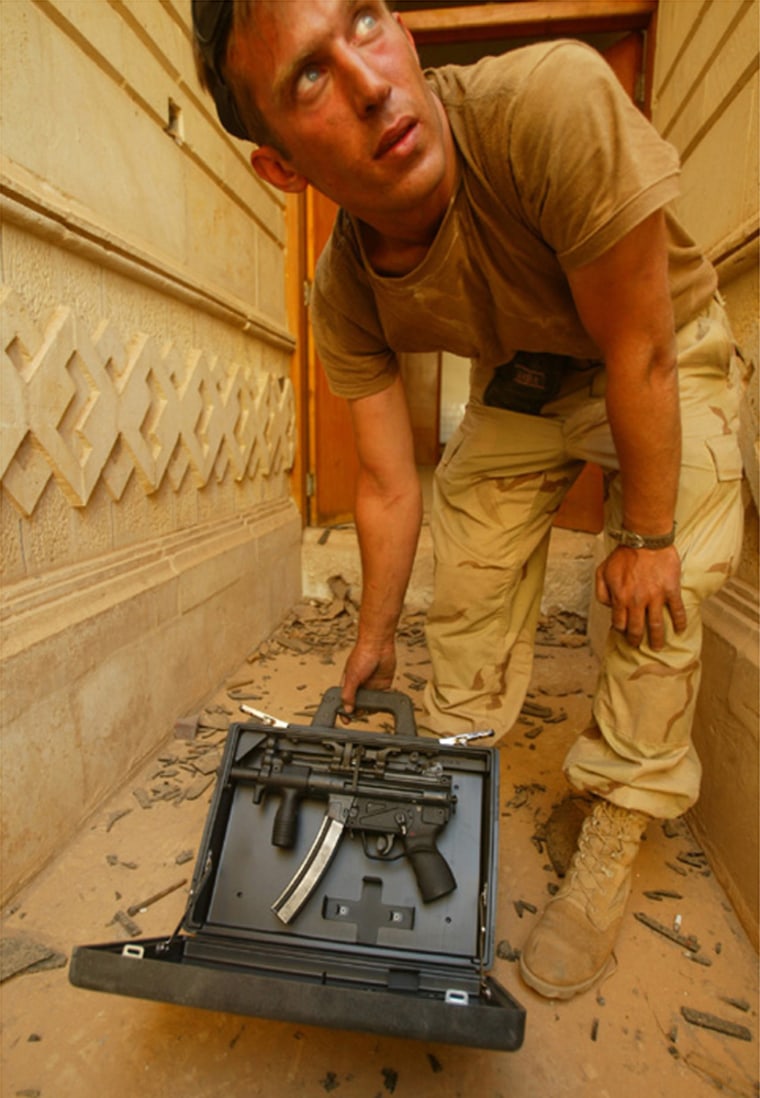 U.S. Army Sgt. Matt Novak, of Wisconsin, with one of the briefcase weapons recovered. LOS ANGELES TIMES PHOTO BY RICK LOOMIS