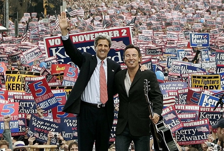 U.S. Democratic presidential nominee John Kerry waves to crowd at rally with musician Bruce Springsteen