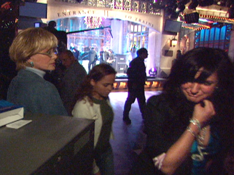 **FILE**A teary Ashlee Simpson, right, runs off stage clutching her throat at the dress rehearsal for NBC's