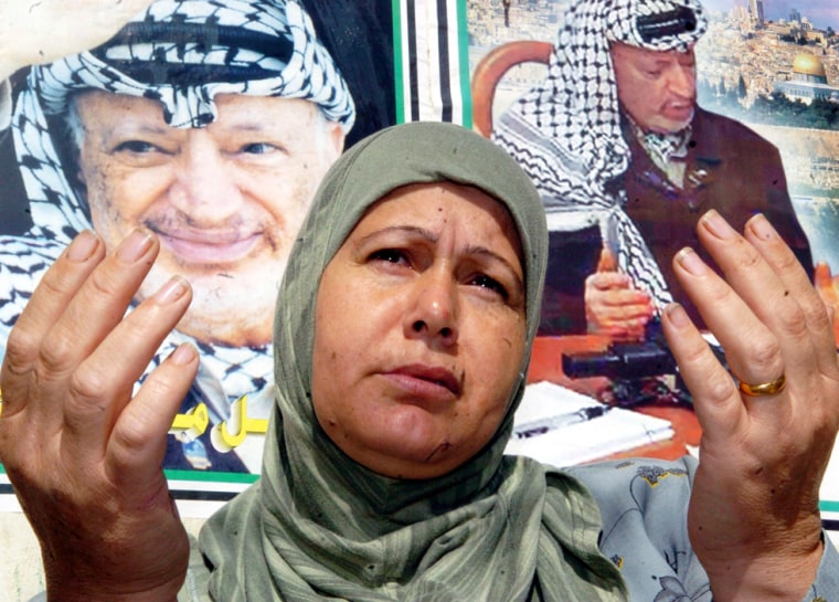 A Palestinian woman  prays for Palestinian leader Yasser Arafat's health at a-Al-Bourj refugee camp in Beirut, Lebanon, Wednesday Nov. 10, 2004. Arafat is in a deep coma at the Percy Military hospital in France.(AP Photo/Adnan Hajj Ali)