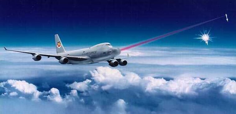 An artist's conception shows an airborne laser system being fired at a missile during its ascent.