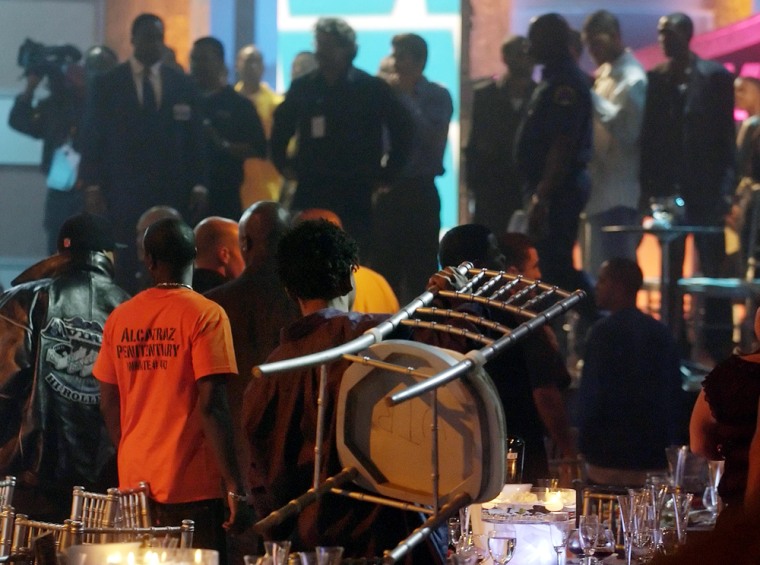 An audience member holds up a chair shortly after a fight broke out in the audience at the Second Annual Vibe Awards at Barker Hangar in Santa Monica, Calif., Monday, Nov. 15, 2004.  (AP Photo/Chris Pizzello)