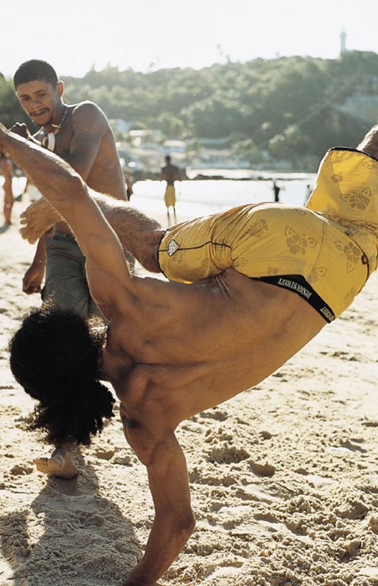 Locals practicing the African-Brailian martial art of capoeira on the beach in Morro de Sao Paulo