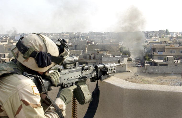 U.S. Marine scans for enemy activity from a rooftop in the Iraqi city of Mosul