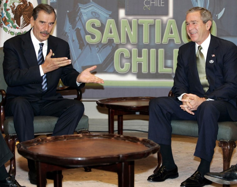 US President Bush listens to Mexican President Vicente Fox in Santiago