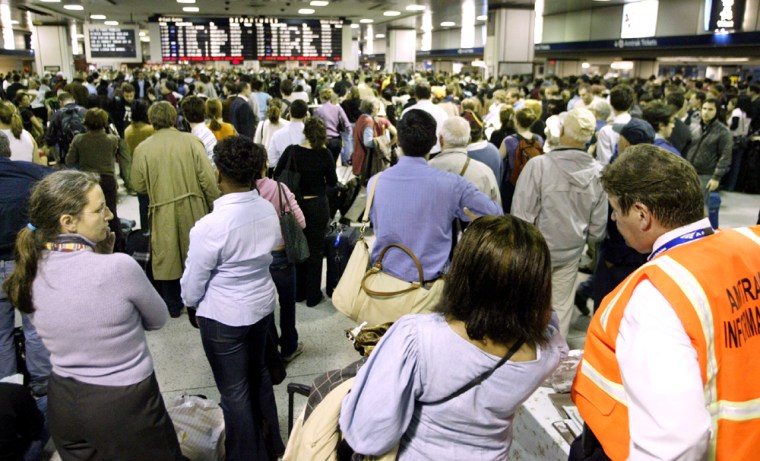 Passengers wait at Amtrak terminal during delays at New York's Pennsylvania Station