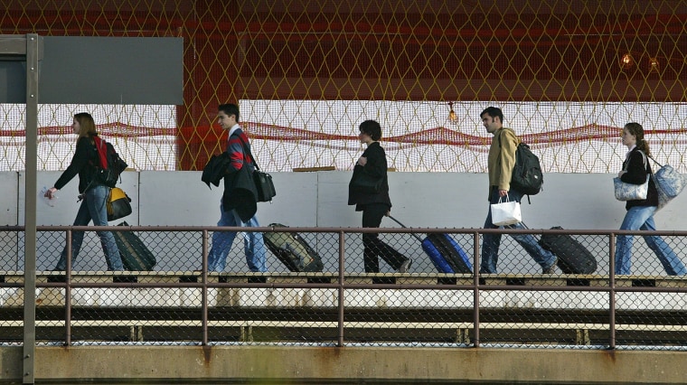 Holiday travelers walk towards Washington's Reagan National Airport.