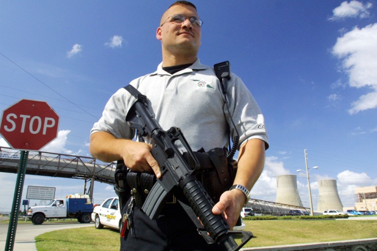 Utility companies that beefed up security after the Sept. 11 attacks are now looking to recoup those costs. Some of those costs are hard to assign, like this county sheriff guarding Florida Power's Crystal River nuclear plant in November 2001.