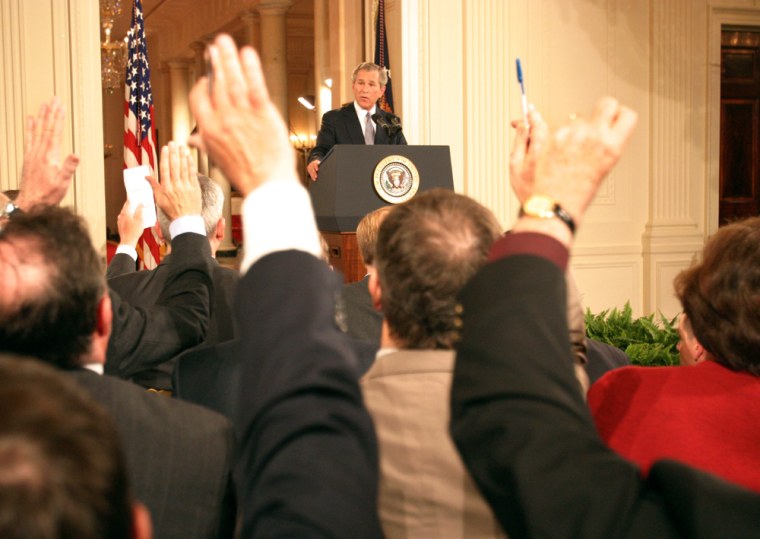 Reporters raise their hands, hoping to be called on by President Bush, at a press conference in Washington on April 13.