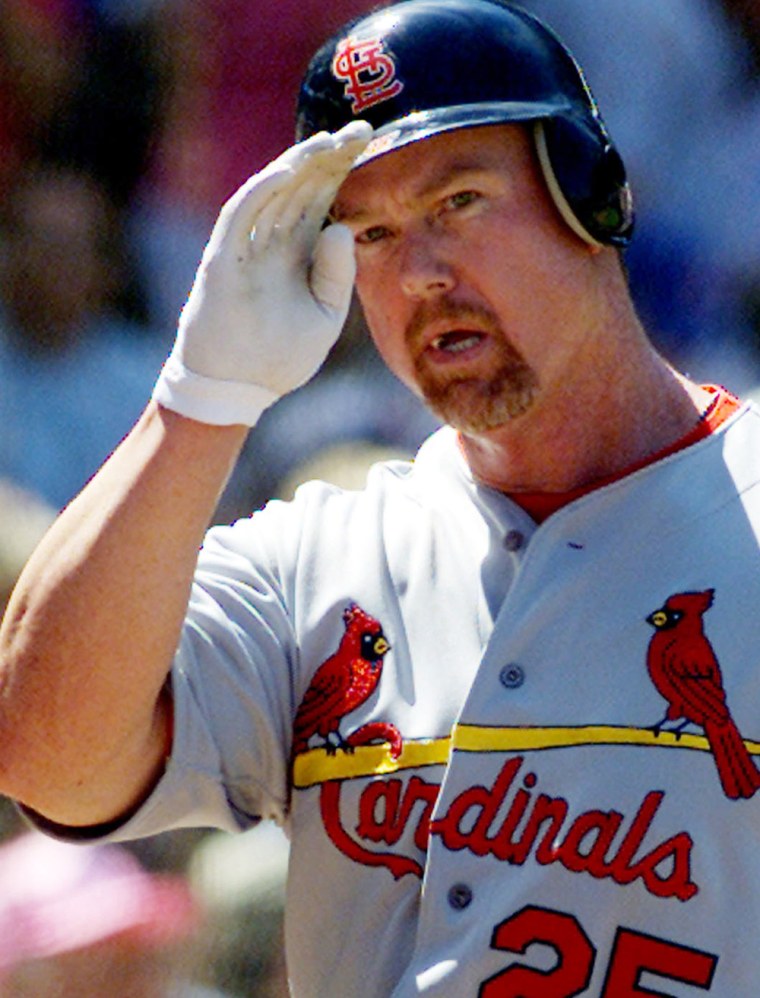 FILE PHOTO OF CARDINALS MCGWIRE SALUTES AFTER HOME RUN AGAINST CUBS