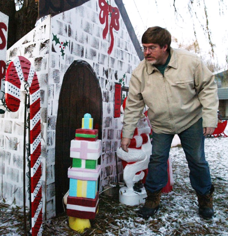 Greg Parcell works on holiday decorations in the front yard of his Geneva, Ill., home Wednesday, Dec. 1, 2004, in Geneva, Ill. Parcell is one of many Christmas enthusiasts who are growing increasingly sophisticated at turning  yards into blazing monuments to the holidays. (AP Photo/Nam Y. Huh)
