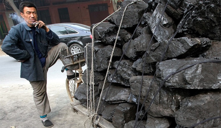 A Chinese man takes a break after loading his coal in Beijing