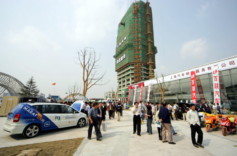 Chinese take in environmentally friendly vehicles shown at the main campus of Shanghai International Automobile City. Major carmakers selling in China each have a pavilion there. The green car event was sponsored by tiremaker Michelin.