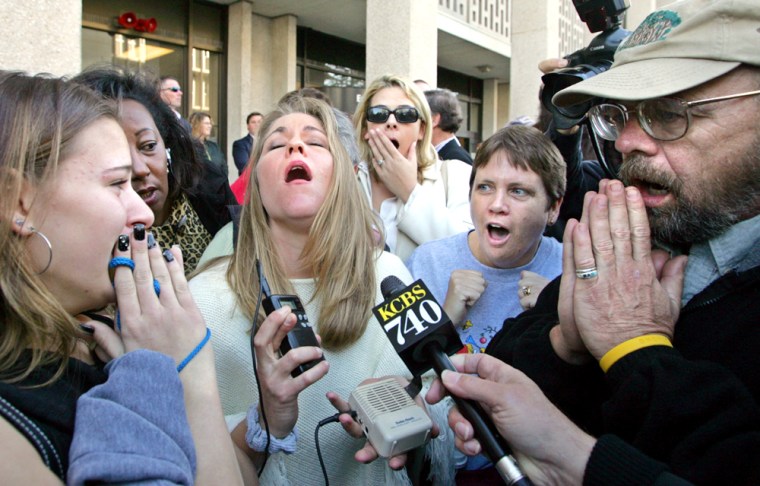 Howard Kutzly, right, Krystyna Wiener, left, and Kimberly Hovorta, second from left in white, react to the verdict outside of the courthouse in Redwood City, Calif., Monday, Dec. 13, 2004. The jury returned with a sentence recommendation of death in the penalty phase of the Scott Peterson case. Peterson was convicted of two counts of murder in the deaths of his wife Laci Peterson and their unborn child. (AP Photo/Justin Sullivan, POOL)