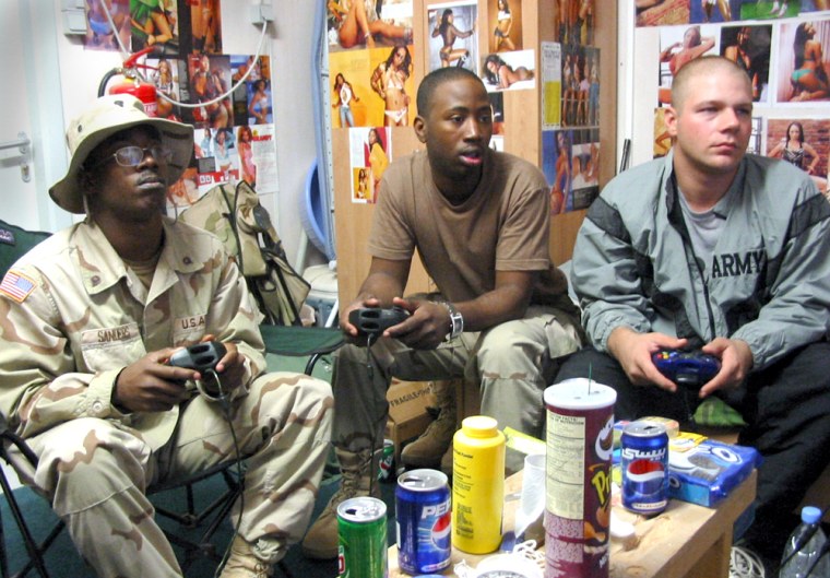 Spec. Criss Sanders, 21, of Miami puts on his game face as he trounces fellow soldiers, Spec. Robert McKinney, 23, of Brooklyn, N.Y., and Pfc. David Usry, 25, of Tampa, Fla., in a game of Halo in a trailer at Camp Liberty, Iraq.