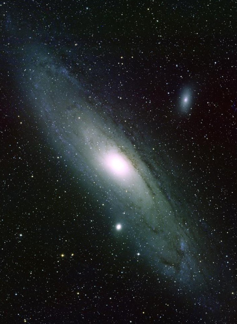 This picture shows the Andromeda Galaxy (M31) and its small companion galaxies M32, lower center, and NGC 205 to the upper right. The image was made by combining three separate frames derived from photographic plates taken in 1979 at the Burrell Schmidt telescope of the Warner and Swasey Observatory of Case Western Reserve University.