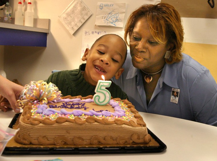 me/mom Saundra Adams and her 5-yrs-old grandson, Chancellor celebrating his fifth birthday at his school in Charlotte, NC.. Her daughter, Cherika Adams was killed five years ago by NC Panthers football star Ray Carruth.Cherika died but she deliverred a boy, Chancellor, who is brain damaged.      StaffPhoto imported to Merlin on  Wed Dec 15 18:42:06 2004