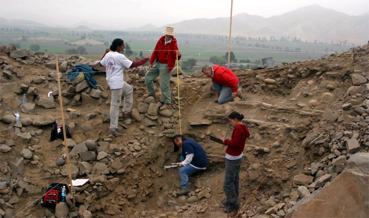 Northern Illinois University team of archaeologists map a cleared surface at the top of a mound at the site of Vinto Alto in the Pativilca Valley. 