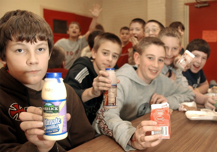 Students at Woddbury Middle School show of their choice for milk containers at lunch in Salem, N.H., Dec. 17.