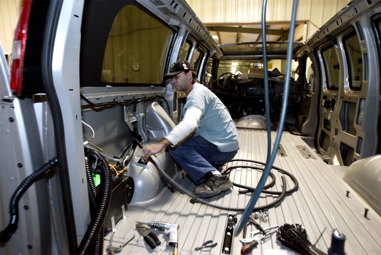 James Wiser installs a rear air conditioner in a van at Southern Comfort Van Conversions in Oneonta, Ala., facility earlier this month. No longer decorated with beads and shag carpeting, conversion vans have evolved into sophisticated vehicles for families and groups alike — a message General Motors is listening to.