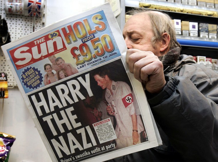 News agent Roy Ottoway reads a copy of tabloid 'The Sun', whose front page shows a picture of Britain's Prince Harry wearing a Nazi soldier's uniform to a fancy dress party, early Thursday morning, Jan. 13, 2005 at King's Cross station in London. The grandson of Queen Elizabeth II apologized Wednesday night after 'The Sun' printed the picture. Prince Harry, the second son of Prince Charles and the late Princess Diana, was shown in early editions of Thursday's issue of \"The Sun,\" clutching a cigarette and a drink and wearing a swastika armband. (AP Photo/Adam Butler) ** PICTURE MAY ONLY BE USED IN ITS ENTIRETY **
