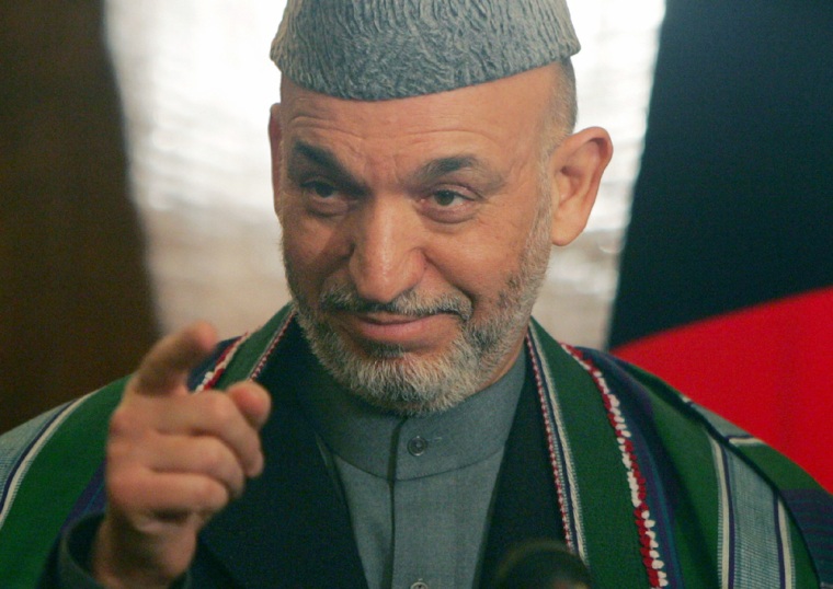 Afghan President Hamid Karzai gestures during a news conference in Kabul