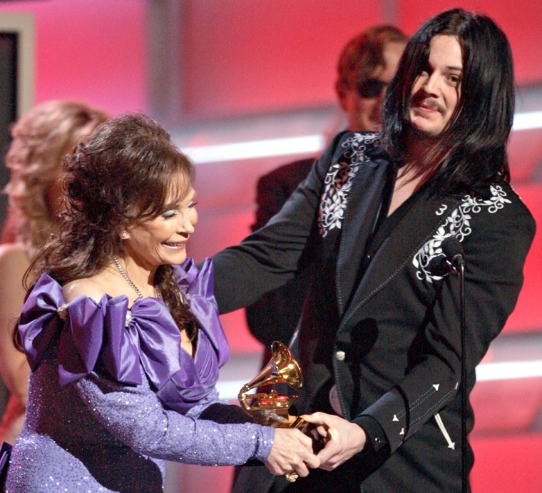 Loretta Lynn accepts the award for best country album for \"Van Lear Rose\" from Jack White, of the band White Stripes, at the 47th Annual Grammy Awards Sunday, Feb. 13, 2005, at the Staples Center in Los Angeles. (AP Photo/Kevork Djansezian)