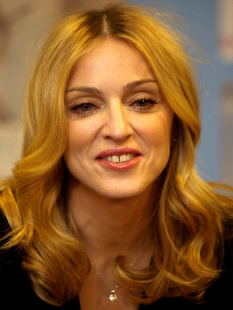 Madonna talks to children during the launch of her fourth book, \"The Adventures of Abdi,\" in a London department store, Thursday Nov. 11, 2004.  Madonna's other books are \"The English Roses,\" \"Mr. Peabody's Apples\" and \"Yakov and the Seven Thieves.\" (AP Photo/Max Nash)