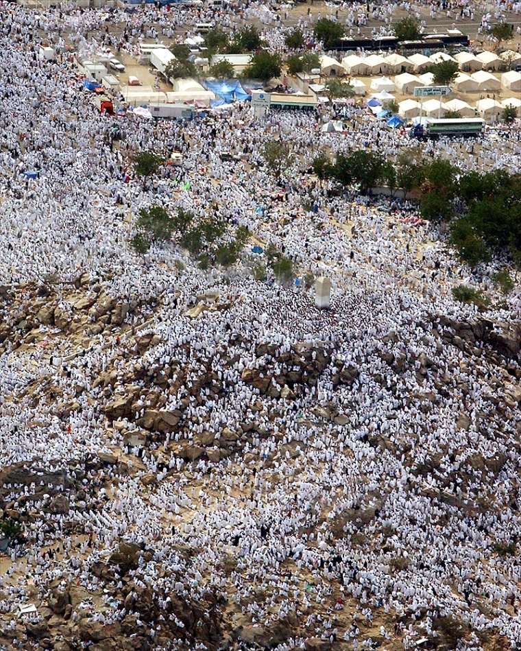 An aerial view showing tens of thousands of pilgrims praying at Jabal Al Rahma holy mountain, the mountain of forgiveness, in Arafat outside Mecca, Saudi Arabia Wednesday, Jan.19, 2005.  More than two millions pilgrims are headed to Arafat for the annual pilgrimage which is one of the most sacred duties of the Muslim faith, required at least once every for able bodied Muslim who can afford it . (AP Photo/Amr Nabil)