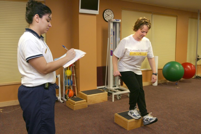 In a test of strength and balance, Denise defies the odds and actually completes a step down as physical therapist Michelle tries not to laugh.