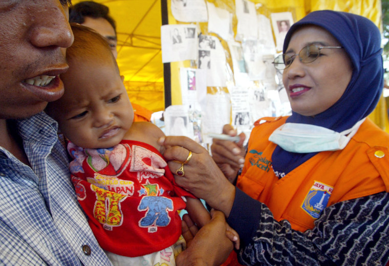 An Acehnese child receives vaccination against measles in a refugee camp in Banda Aceh