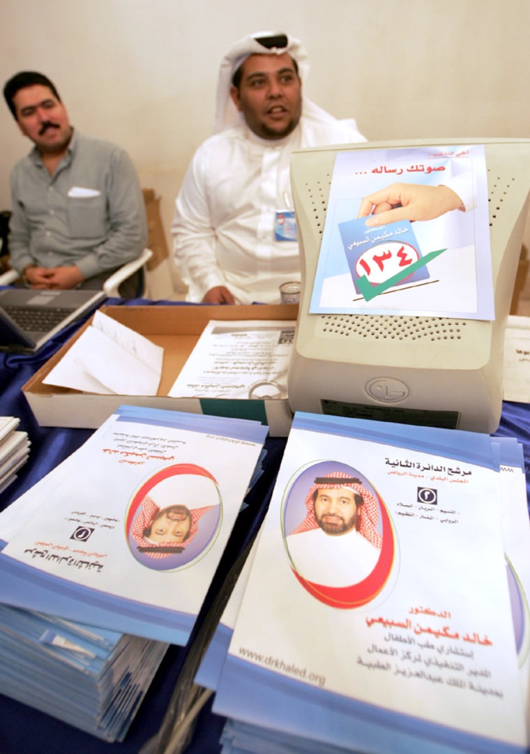 Supporters of Khaled al-Sebaiay, a candidate for Saudi municipal council elections mend the information desk in Riyadh