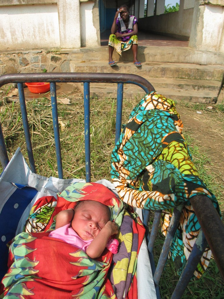 Nsimenya Kinyama, 36, sits near her newborn son, who is not yet named, outside the maternity ward at the hospital in Shabunda, Congo. Kinyama has watched all six of her previous children die.