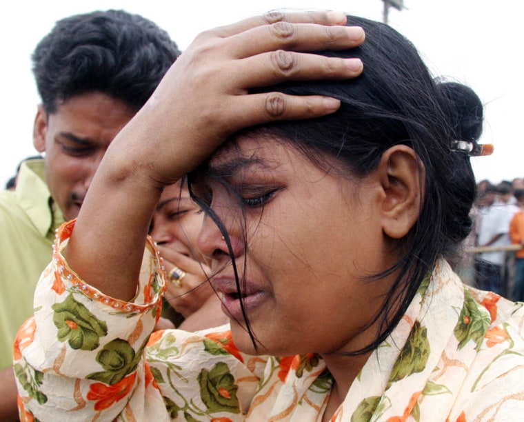 Bangladeshis cry after losing their relatives in a ferry disaster in the Buriganga river, Bangladesh