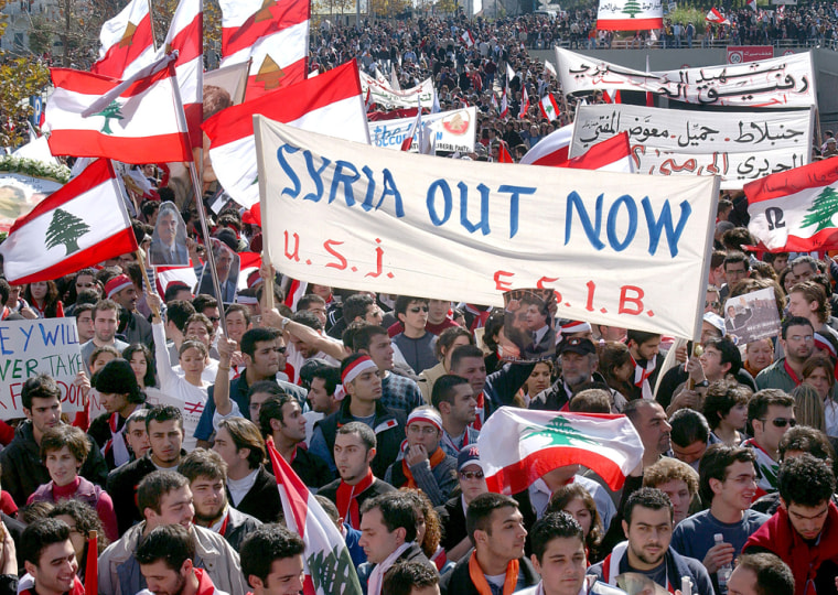 Protestors carrying Lebanese flags marched through much of Beirut on Monday, demanding that Syrian troops leave the country.