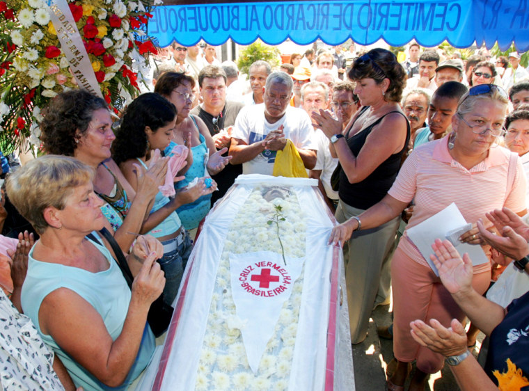 Relatives surround the coffin of Brazilian environmentalist Ribeiro Filho during a funeral in Rio de Janeiro