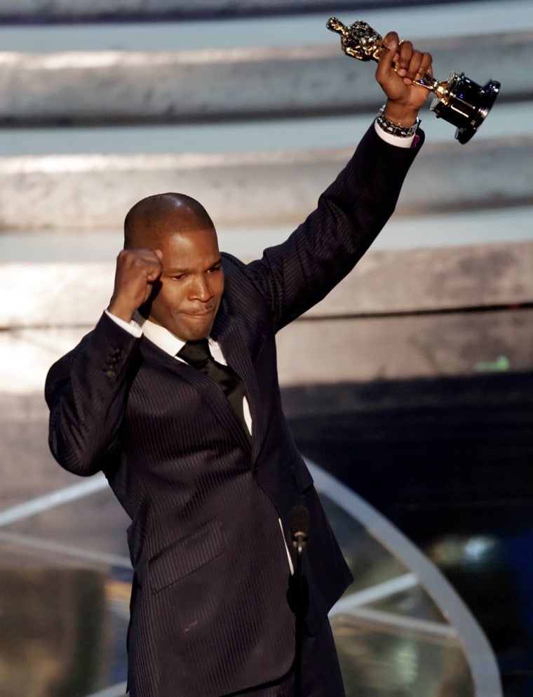 Actor Jamie Foxx celebrates winning the Oscar for best actor at the 77th Academy Awards