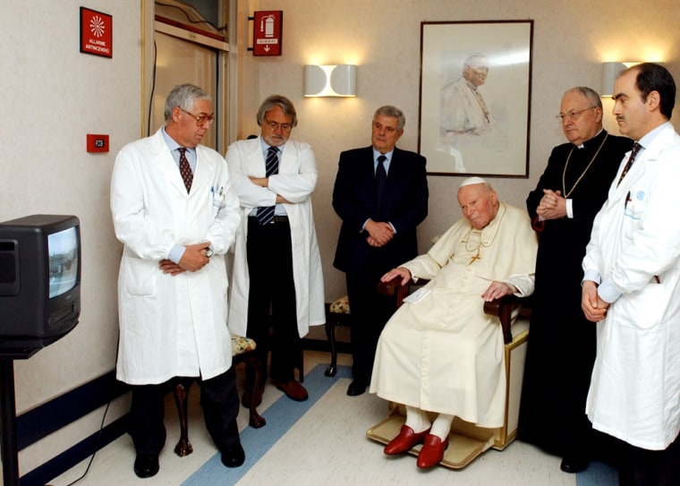 In this photo, made available by the Vatican newspaper Osservatore Romano, Pope John Paul II looks at a televised transmission from St. Peter’s Square from his hospital room at Gemelli Polyclinic hospital in Rome on Sunday. 