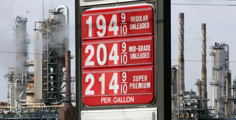 Fuel prices are displayed at a gas station across the street from a Citgo refinery