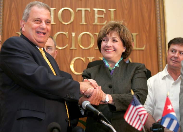 Louisiana state Governor Kathleen Blanco shakes hands with Alvarez from Cuban food import agency Alimport