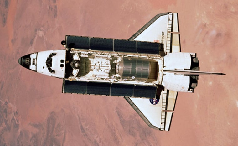 In a 2001 picture taken from the international space station, the Raffaello supply module can be seen sitting in the back half of the shuttle Endeavour's payload bay. Northern Africa serves as a backdrop for the scene.