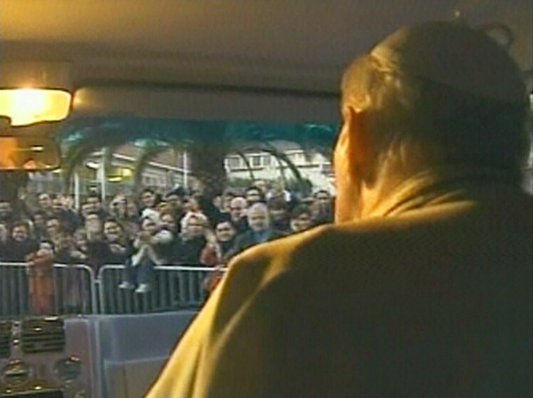 Crowds cheer Pope John Paul II, right, as he rides in a van through Rome on Sunday.