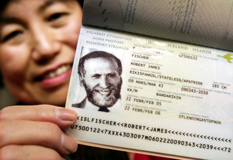 Watai, fiancee of chess grand master Bobby Fischer, shows his new Iceland passport in Tokyo
