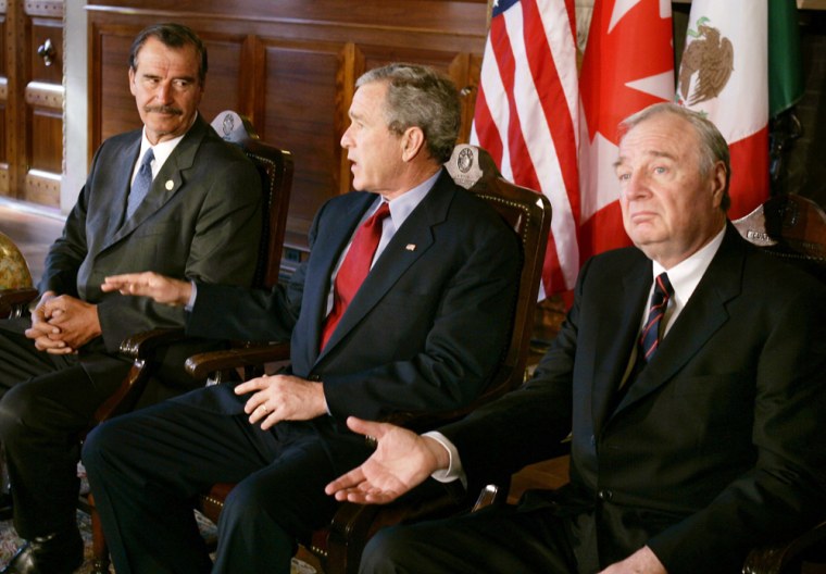 U.S. President George W. Bush speaks with Canadian Prime Minister Martin and Mexican President Fox in Waco