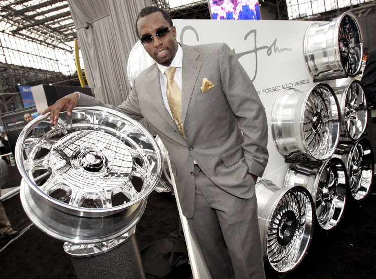 Sean "P. Diddy" Combs poses with his new line of "Sean John Wheels" at the New York International Auto Show on March 24.