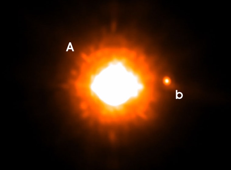 The bright young star GQ Lupi is at the center of this image, and the outlying planet can be seen to the right, labeled "b."