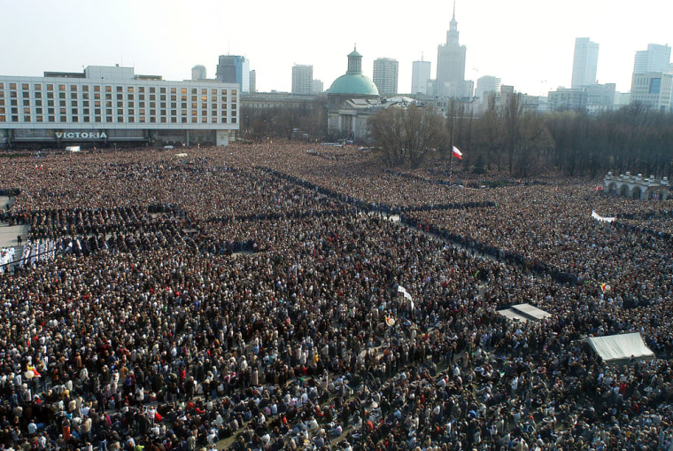 Polish faithful pray during a special mass for the late Pope John Paul II at Pilsudski Square in Warsaw