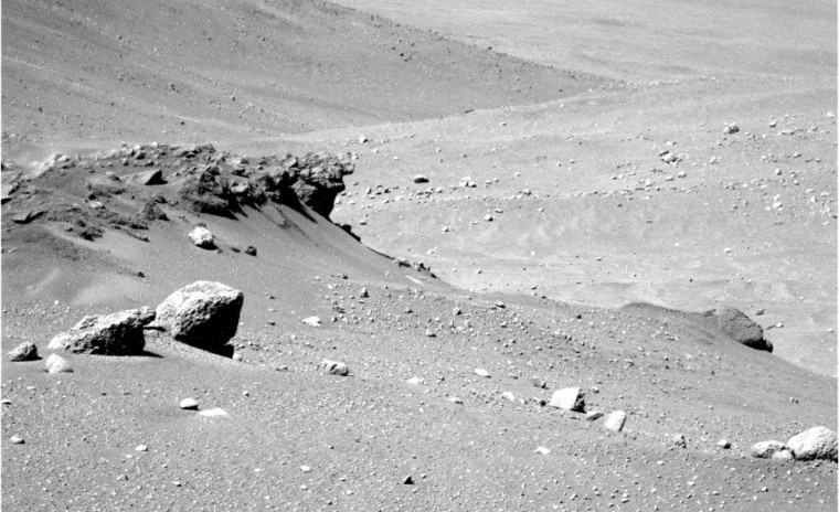 This view from NASA's Spirit rover shows an unusual rock overhang in Mars' Columbia Hills, with other slopes in the distance.