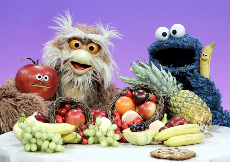 Sesame Street's Hoots the Owl, left, explains the benefits of healthy fruits to Cookie Monster with a song called "A Cookie is a Sometimes Food," in a segment that aired on the children's show in 2004.